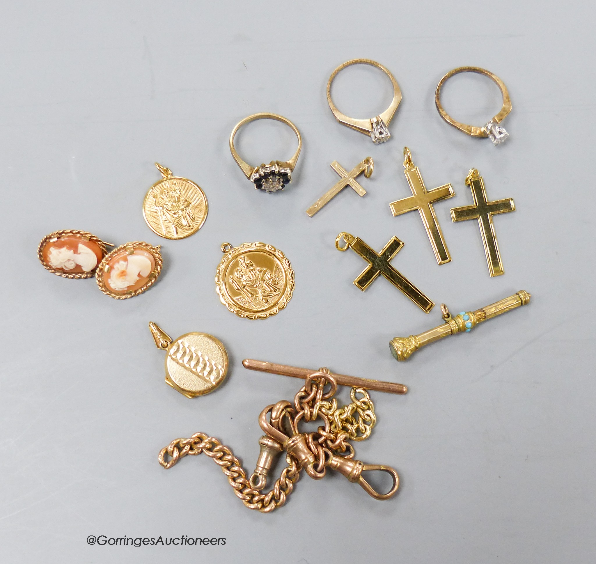 Part of a 9ct gold albert, four 9ct cross pendants, a pair of 9ct earrings, three 9ct and gem set rings, a propelling pencil and two 9ct St Christopher pendants.